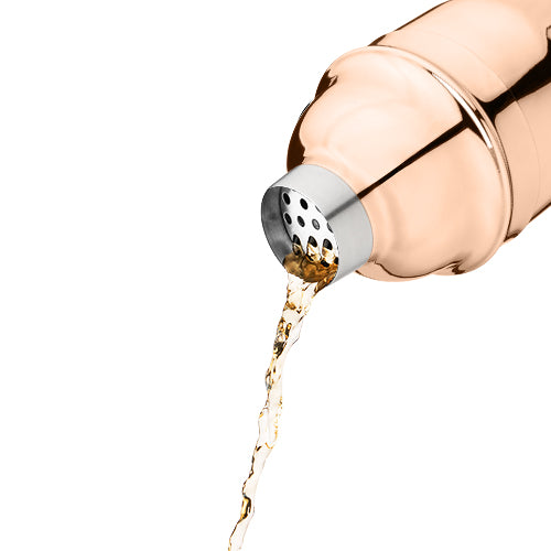 a copper cocktail shaker pouring a drink